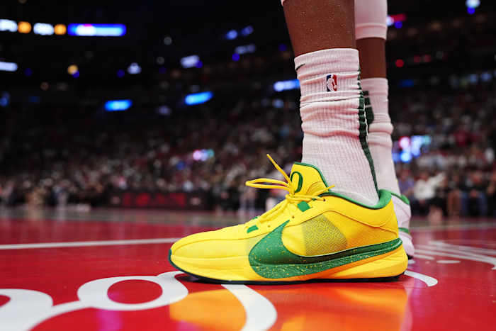 Milwaukee Bucks forward Giannis Antetokounmpo's yellow and green Nike sneakers.